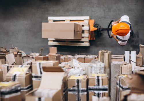 Young man working at a warehouse with boxes